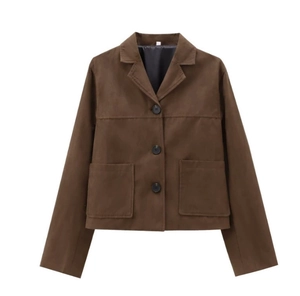 Detail of dark brown suede jacket featuring button closure and front patch pockets