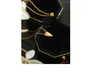 Macro shot of 12 Zodiac necklaces with Aquarius and Aries gold shell pendants