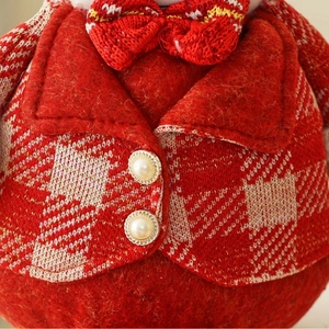 Knitted Christmas gnome ornament with red plaid vest, gold edges and pearl buttons