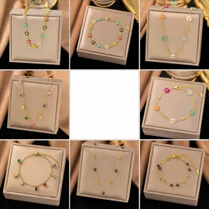 Detail view of gold chain necklaces and bracelets sets with floral and crystal pendants