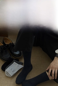 Detail of high-elasticity business mid-calf socks shown with leather shoes