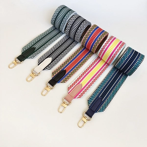 Detail of colorful woven shoulder straps with adjustable golden metal rotating buckles