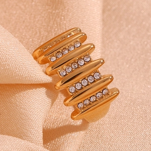 Macro detail of 18K gold-plated multi-layer ring with sparkling pave cubic zirconia