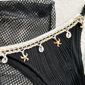 Detail of bikini bottom with starfish charms, shell pendants and crochet trim details
