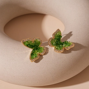 Elegant gold plated butterfly stud earrings featuring green zircon crystals and fine stones