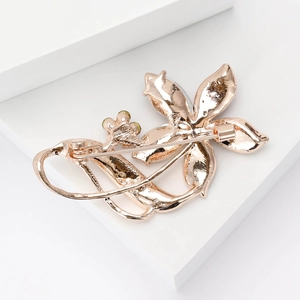Detailed back view of a flower brooch in rose gold with secure pin clasp and metal finish