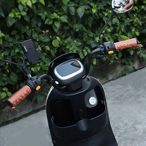 Close-up of vintage brown leather handlebar grips with lace-up stitching for motorcycles