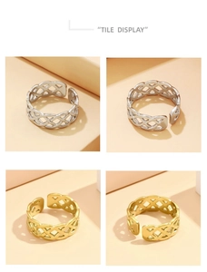 Tile display of braided knot stainless steel open rings in gold and silver finishes