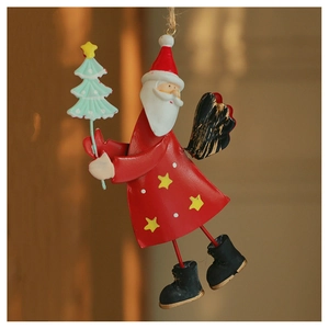 Detail of hanging metal Santa ornament holding a Christmas tree with red paint and hemp rope