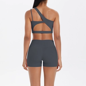 Detail view of charcoal gray two-piece yoga set with cutout bra and high-waist shorts