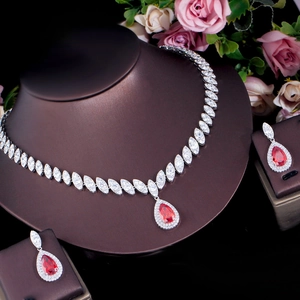 Detail of bridal jewelry set featuring red teardrop stones and zircon necklace