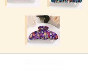 Detailed close-up of acrylic floral hair claws with purple and blue flower patterns