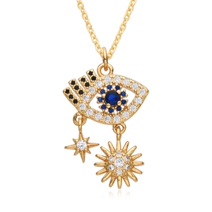 Golden Evil Eye necklace with sun and star charms featuring blue stones and micro-inlays