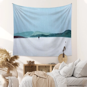 Detail of minimalist mountain landscape tapestry hanging in a cozy bedroom setup