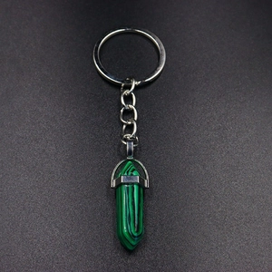 Detail of silver hexagonal green malachite stone pendant on metal keychain