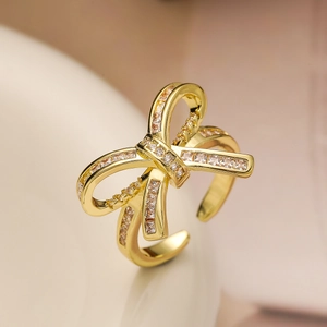 18K gold plated bow ring with sparkling cubic zirconia and adjustable open band design