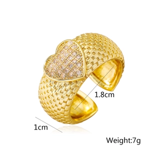 Detailed view of 18K gold plated heart ring with cubic zirconia and woven band
