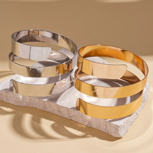 Three-layer geometric metal cuff bracelet with polished gold and silver finish
