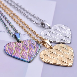 Three heart-shaped textured pendants in silver, gold, and rainbow finish on chains