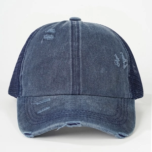 Detail of distressed denim blue baseball cap with breathable mesh and vintage torn holes