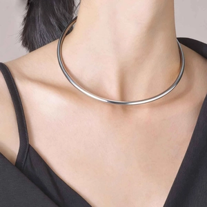 Close-up of a minimalist polished silver stainless steel choker collar on a model