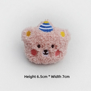 Detail of pink curly plush bear accessory with embroidery hat, sized 6.5cm by 7cm
