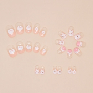 Detailed view of short press-on nails featuring cute bunny, floral, and polka dot designs