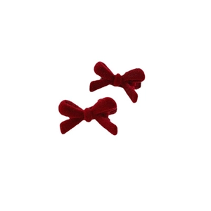 Pair of red velvet bow hair clips with plush texture and classic vintage metal grips