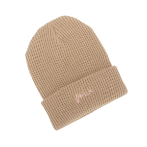 Detail of beige ribbed knit beanie with pink me embroidery on the folded cuff