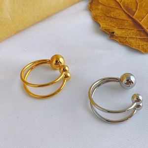 Macro shot of 18k gold and silver titanium steel open rings with minimalist double layer design