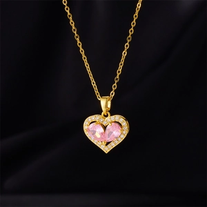 Pink heart necklace with gold bow pendant and small white zircon inlay on silk