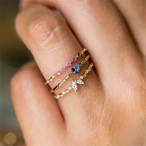 Macro shot of S925 sterling silver stacked rings with colorful zircon and gold finish