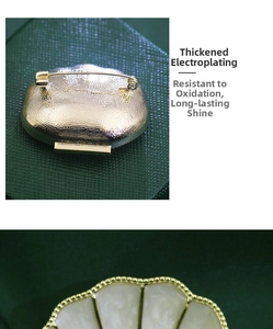 Detail of French vintage shell brooch showing back safety pin and thick gold plating