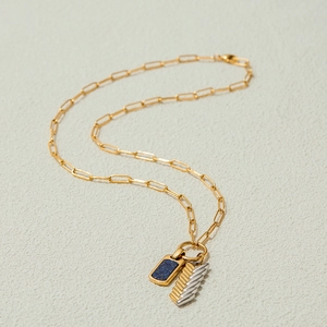 Detail of paperclip chain necklace with blue lapis lazuli and feather charm