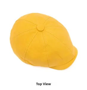 Top view of yellow newsboy cap showing classic octagonal panel design and center button