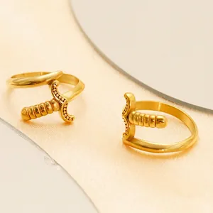 Vintage style 18K gold-plated stainless steel dagger rings with embossed details