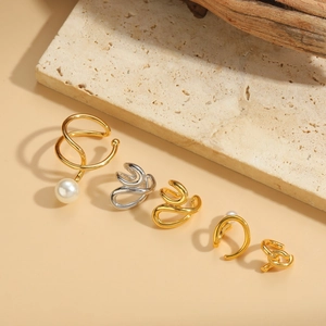 Minimalist geometric pearl ear cuffs in gold and silver finish on textured stone