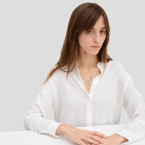 Minimalist 925 sterling silver liquid lava necklace on model wearing white shirt