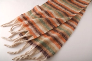 Close-up of winter striped scarf with fluffy faux cashmere texture and thick tassels