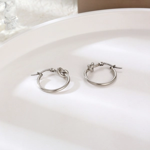 Minimalist silver-tone knotted hoop earrings in durable stainless steel for women
