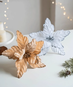 Detail of glitter champagne gold poinsettia flowers for festive Christmas tree decor