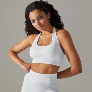Detail of white seamless knitted yoga set with ribbed hem and halter neck sports bra