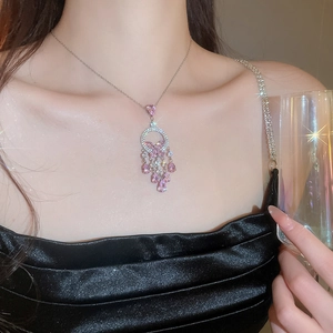 Detail of pink crystal tassel necklace with silver chain on model for evening party