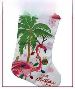 Detail of Christmas stocking featuring tropical flamingo and palm tree patterns