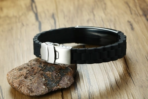Detail of black silicone bracelet with silver stainless steel brushed folding clasp