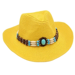 Detailed view of a bright yellow woven straw sun hat with ethnic turquoise beaded band