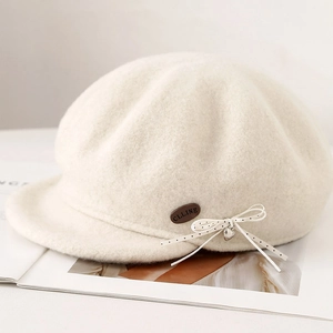 Elegant cream wool newsboy cap with polka dot bow and silver heart pendant decoration