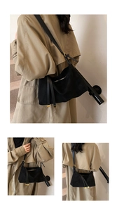 Detail of black suede hobo bag featuring long tassels and premium gold zipper hardware