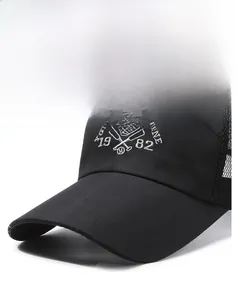 Detail of black and white mesh trucker hat featuring embroidered sport logo on front