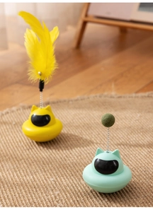 Detail of tumbler cat toy with suction cup base and flexible spring feather attachment